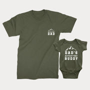 A military green t-shirt for adults and a military green bodysuit for babies with text 'ADVENTURE DAD' and 'DAD'S ADVENTURE BUDDY' printed on them.