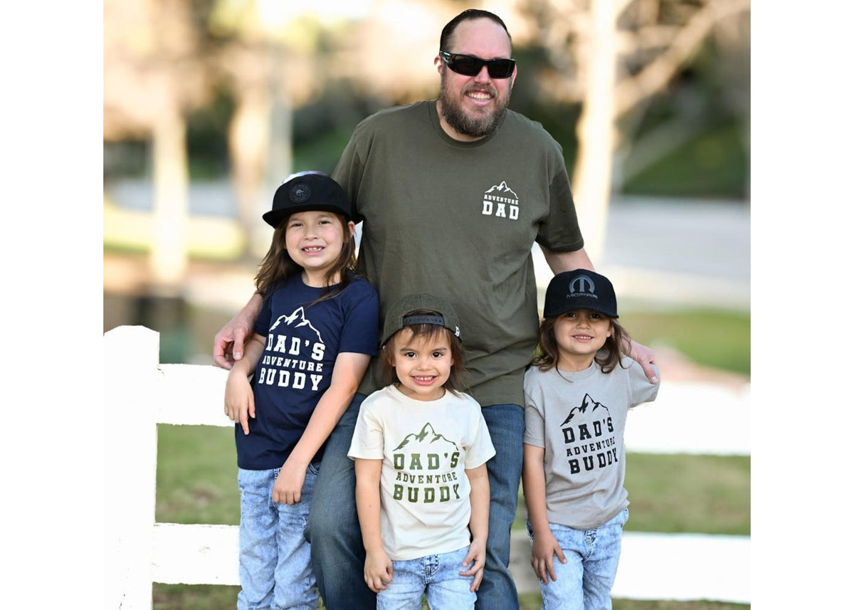 Man with three children wearing matching t-shirts outdoors