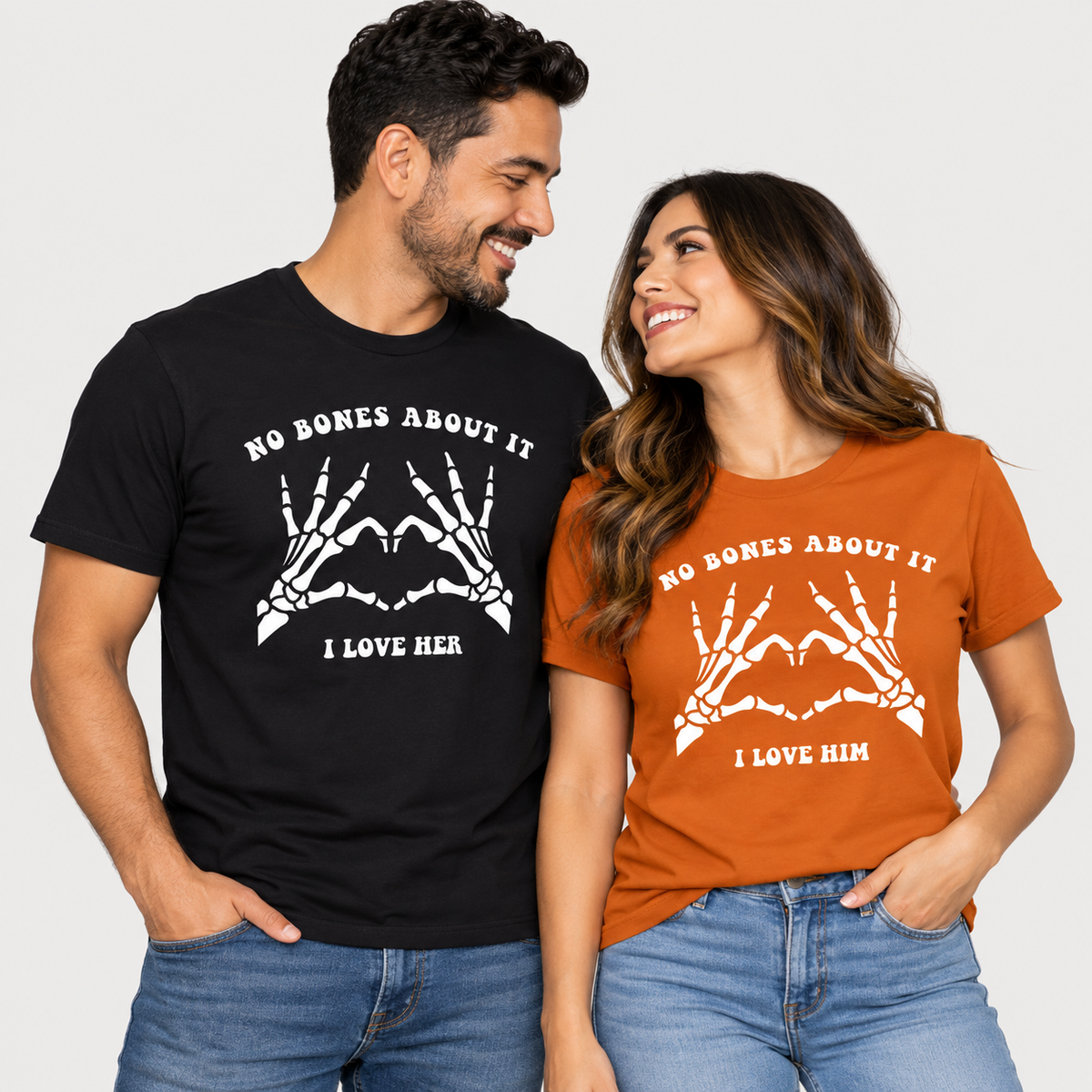 TeeLikeYours matching Halloween couple T-shirts featuring “No Bones About It” skeleton hand heart designs, with “I Love Her” and “I Love Him” prints
