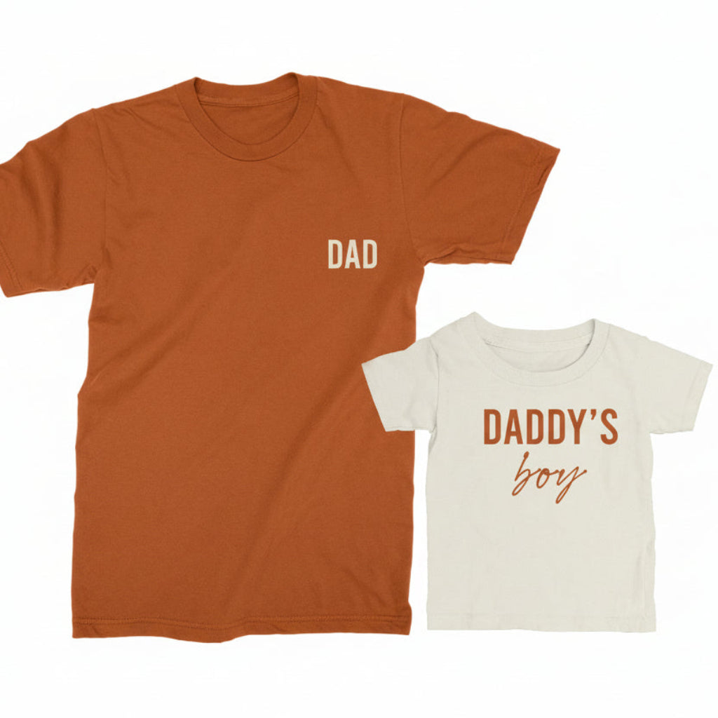 Autumn 'DAD' t-shirt and natural 'DADDY'S BOY' t-shirt on a white background