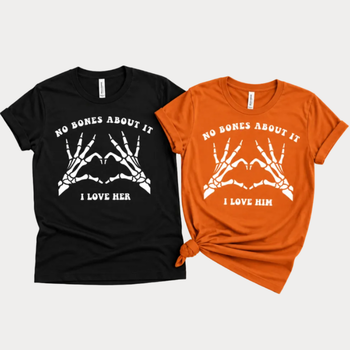 TeeLikeYours matching Halloween couple T-shirts featuring “No Bones About It” skeleton hand heart designs with “I Love Her” and “I Love Him” prints