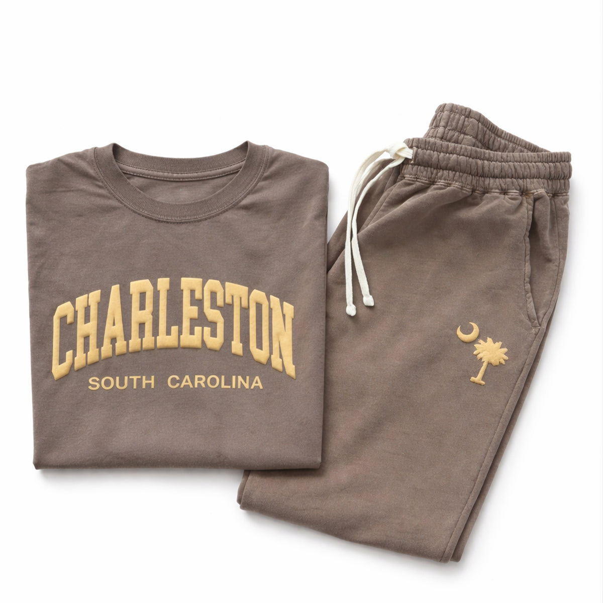 Folded Charleston South Carolina puff print Comfort Colors® t-shirt and sweatpants set in espresso color displayed on white background