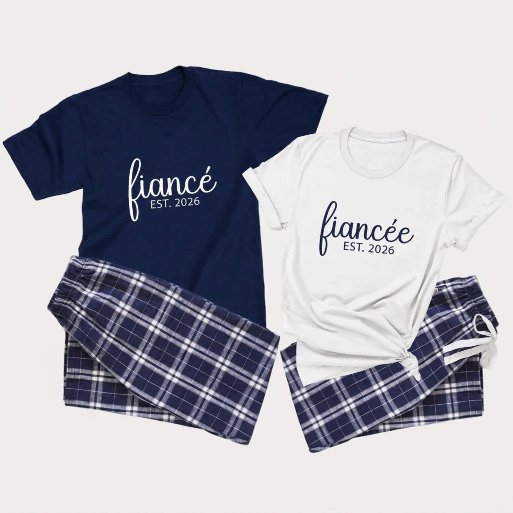 Fiancé and fiancée matching engagement pajama set featuring unisex T-shirts with engagement lettering and coordinating navy and silver plaid flannel pajama pants.