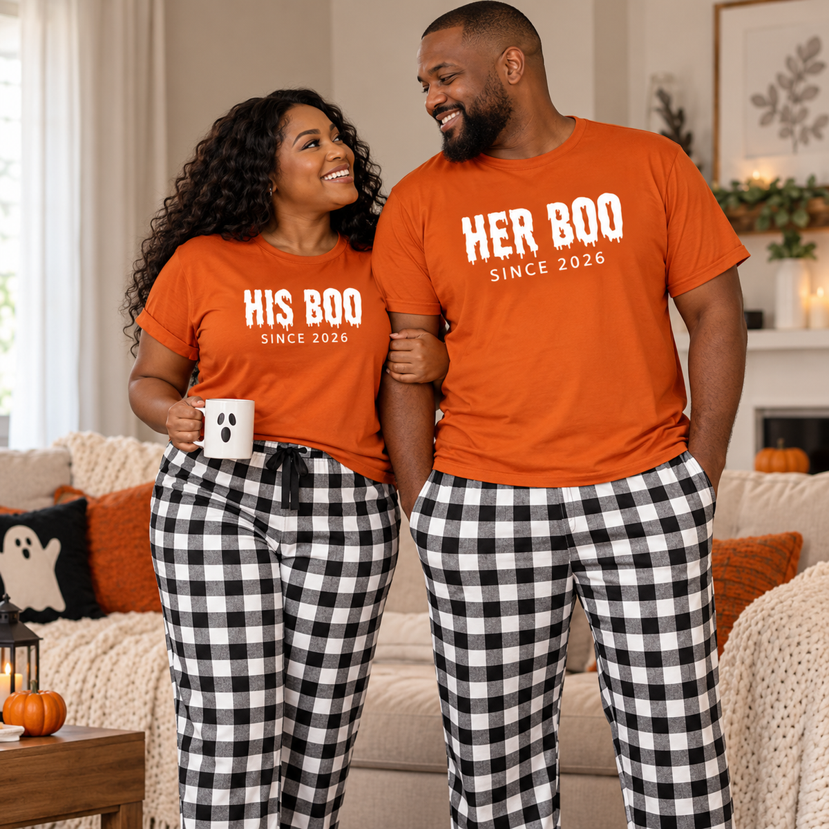 Couple wearing matching His Boo and Her Boo autumn T-shirts with black and white flannel pajama pants in a cozy interior