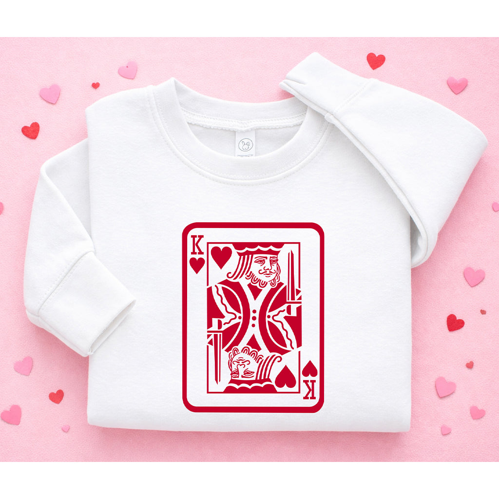 Kids white Valentine’s Day sweatshirt with king card design displayed on a pink background