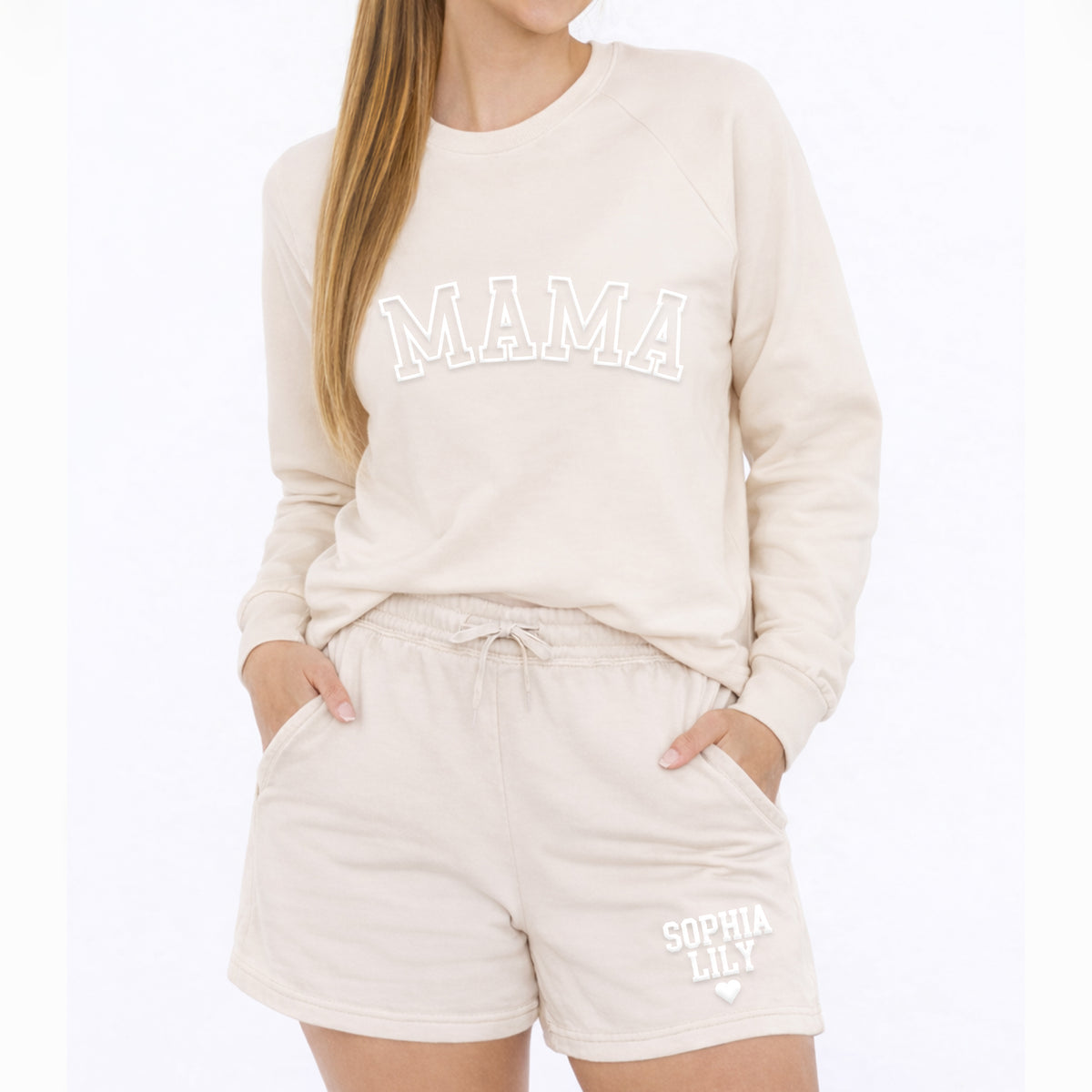 Woman wearing bone color Mama crewneck sweatshirt and personalized sweatshorts with custom kids names, casual lounge set.