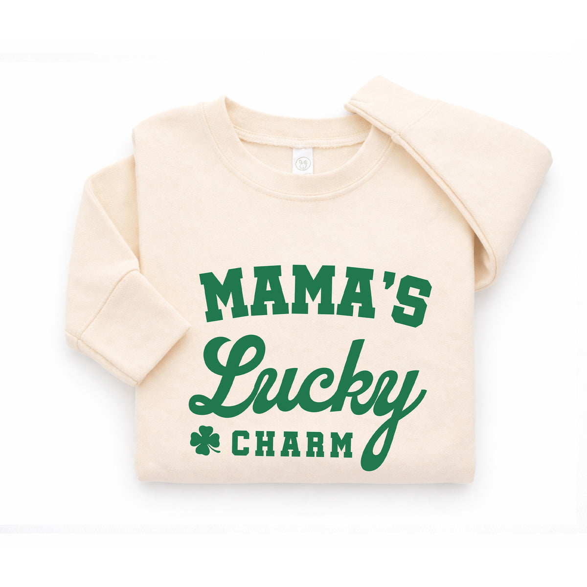 Folded natural Mama’s Lucky Charm toddler sweatshirt with green shamrock St. Patrick’s Day design.