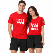 Matching couples pajama set with man and woman wearing red “Love You” and “Love You More” t-shirts and black boxer shorts on a white background