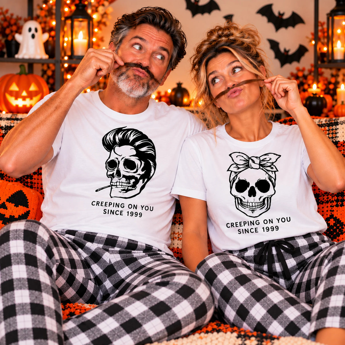 Matching Halloween couple pajamas with skeleton designs and personalized “Creeping on You Since 1999” shirts