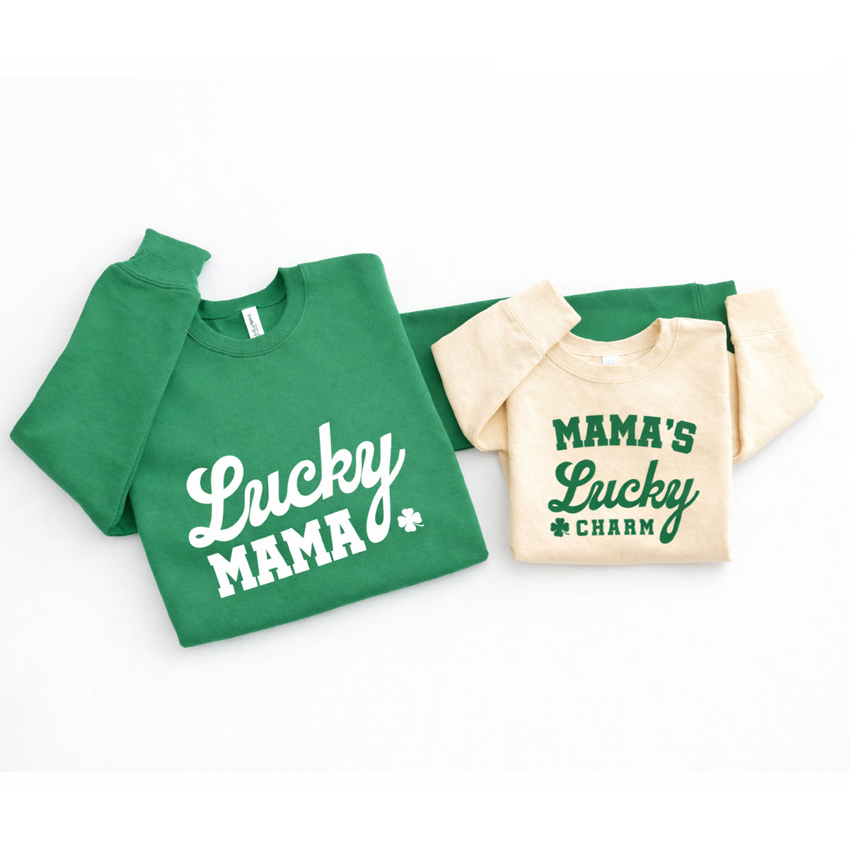 Green Lucky Mama and natural Mama’s Lucky Charm matching St. Patrick’s Day sweatshirts side by side.