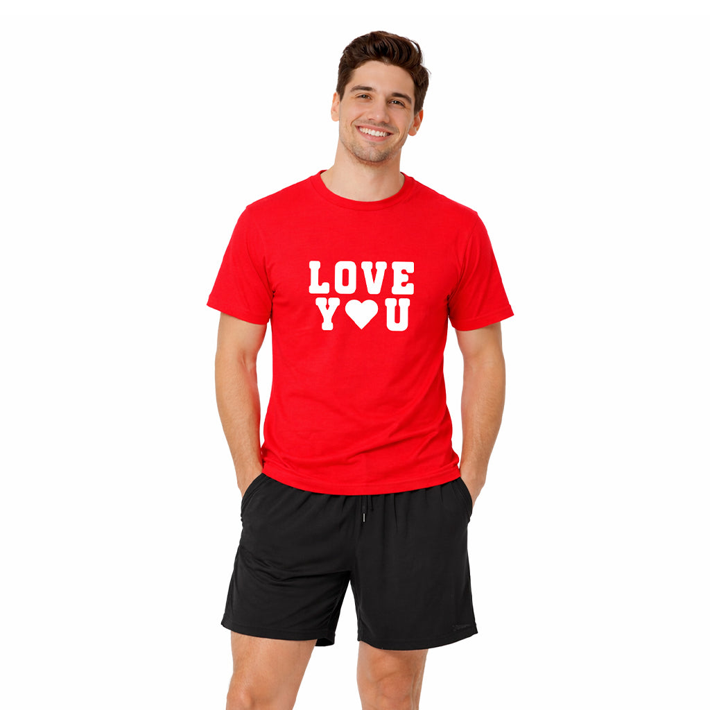 Man wearing the “Love You” pajama set with red t-shirt and black boxer shorts, men’s loungewear and sleepwear