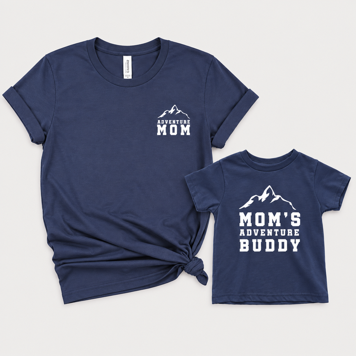 Navy Blue matching mom and child T-shirts with white mountain graphics and “Adventure Mom” and “Mom’s Adventure Buddy” lettering.
