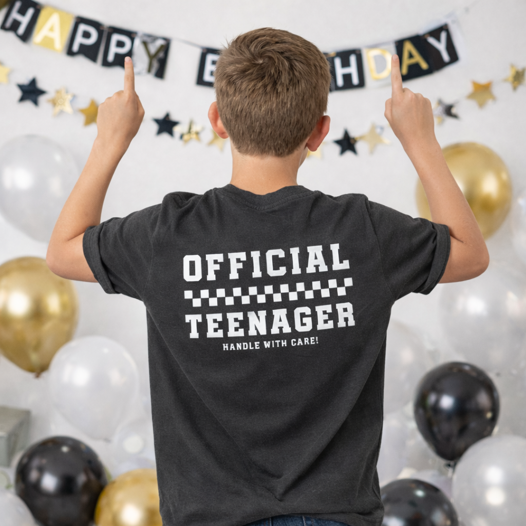 Back view of pepper 13th birthday t-shirt worn by teenage boy featuring “Official Teenager Handle With Care” print