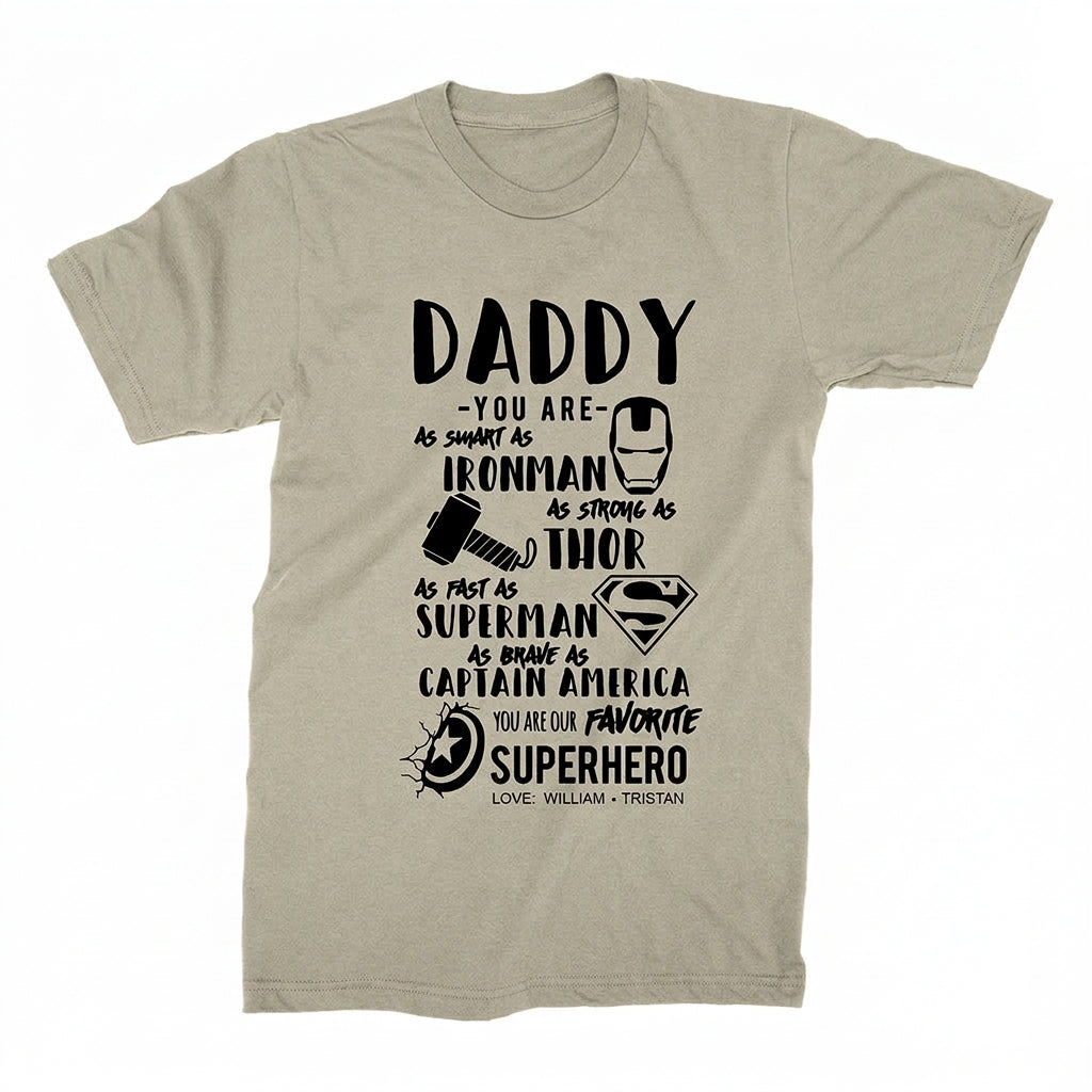 Personalized Daddy superhero T-shirt in heather stone featuring Iron Man, Thor, Superman, and Captain America designs with custom children's names.