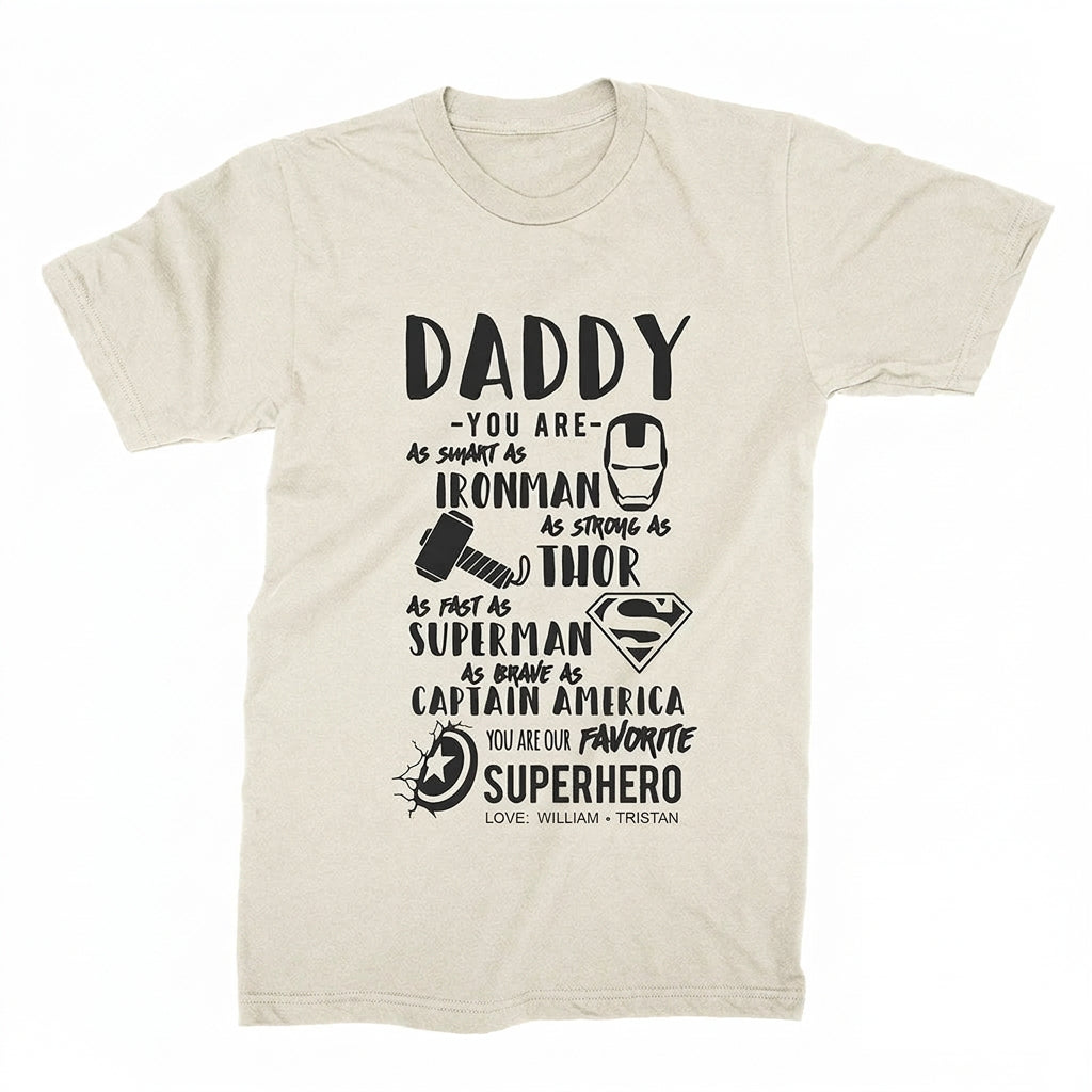 Personalized Daddy superhero T-shirt in natural featuring Iron Man, Thor, Superman, and Captain America designs with custom children's names.