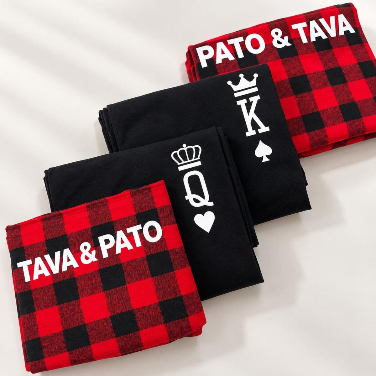 Personalized King and Queen Christmas pajamas featuring folded T-shirts with royal crown designs and buffalo plaid flannel pajama pants customized with the names Pato and Tava.