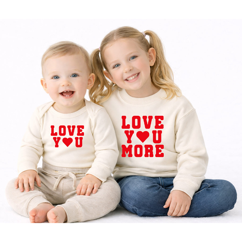 Sibling matching sweatshirts with “Love You More” for big sister and “Love You” for baby brother in natural color