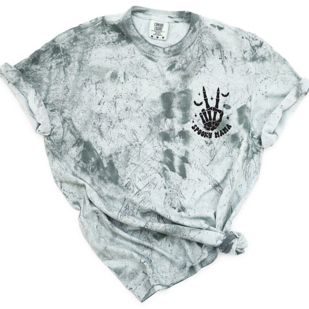 Spooky Mama Halloween shirt with black skeleton hand, bats, stars, and Spooky Mama graphic on a garment-dyed t-shirt