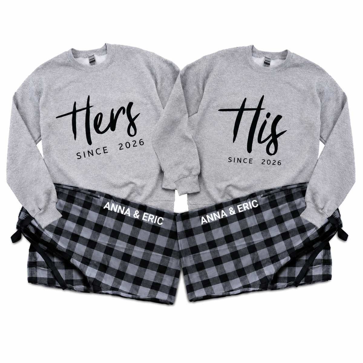 Matching His and Hers personalized gray sweatshirts with “Since 2026” prints and black-and-gray plaid pajama pants personalized with Anna & Eric.