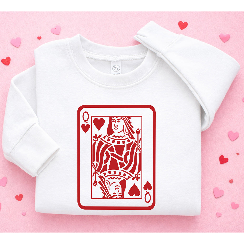 White kids Valentine’s Day sweatshirt featuring Queen card graphic on pink background with heart accents