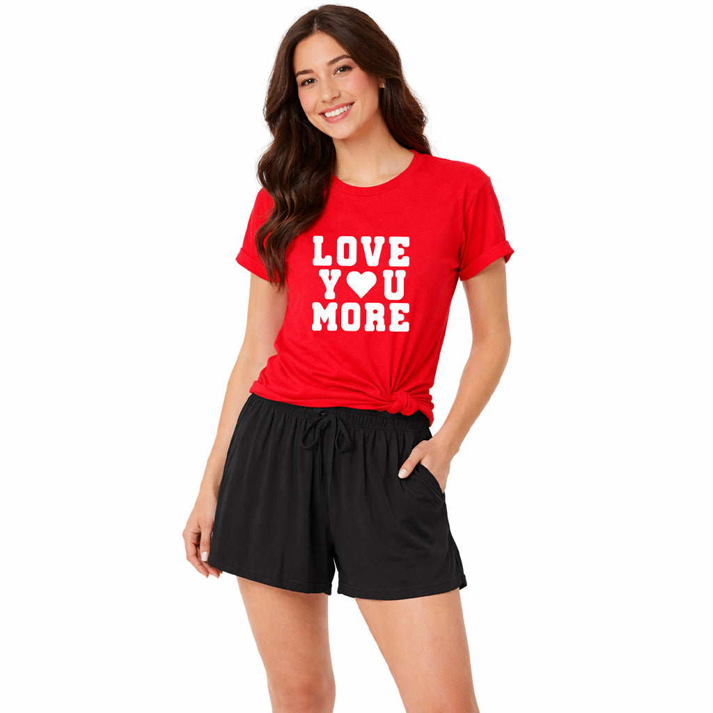 Woman wearing the “Love You More” pajama set with red t-shirt and black boxer shorts, women’s loungewear style