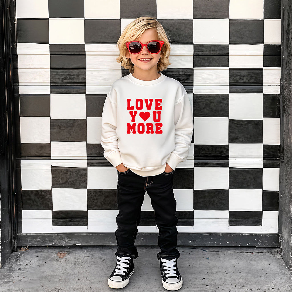 Young boy wearing natural color “Love You More” sweatshirt on checkered background