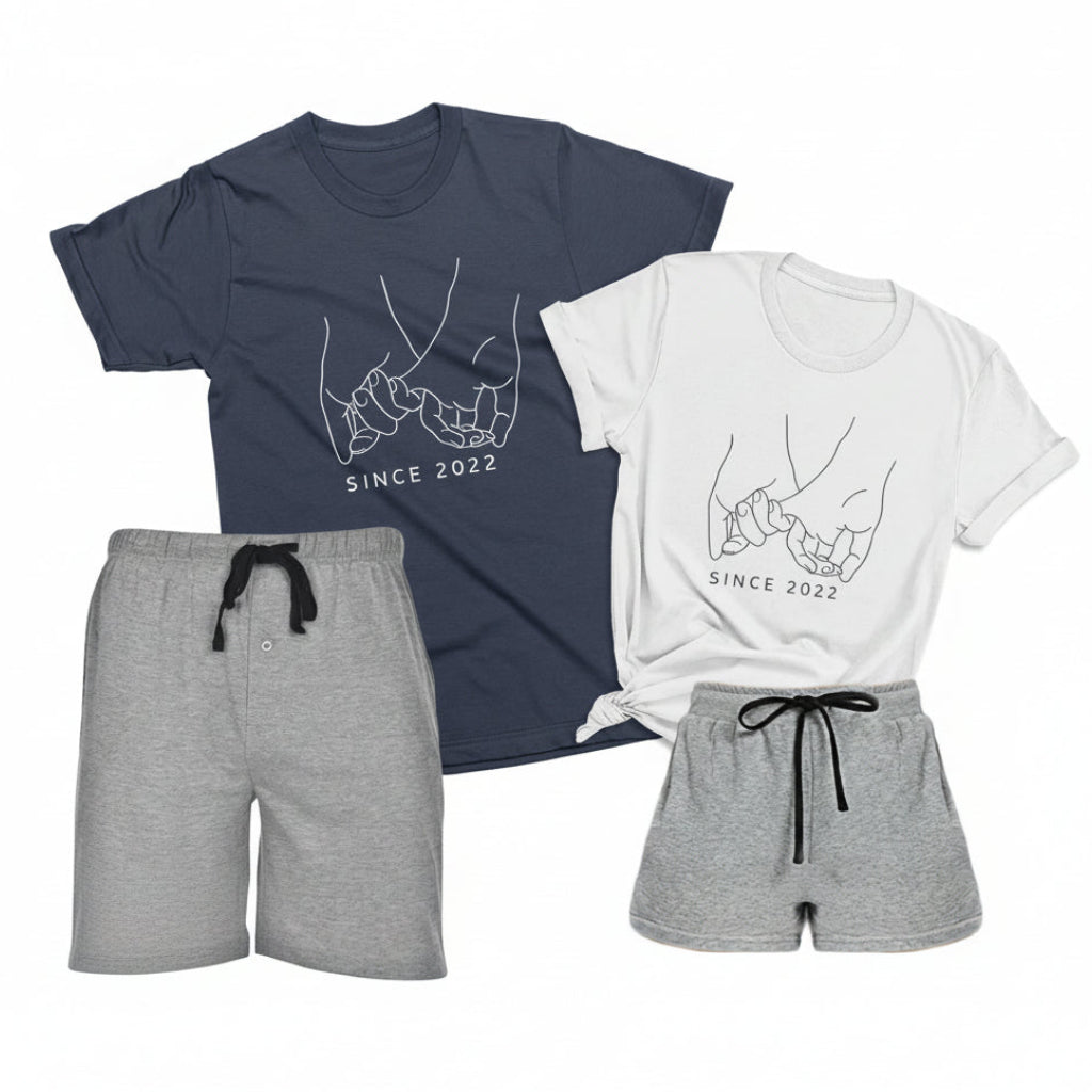 Matching couples pajama set with gray boxer shorts, navy blue men’s t-shirt, and white women’s t-shirt with personalized pinky promise and custom year design