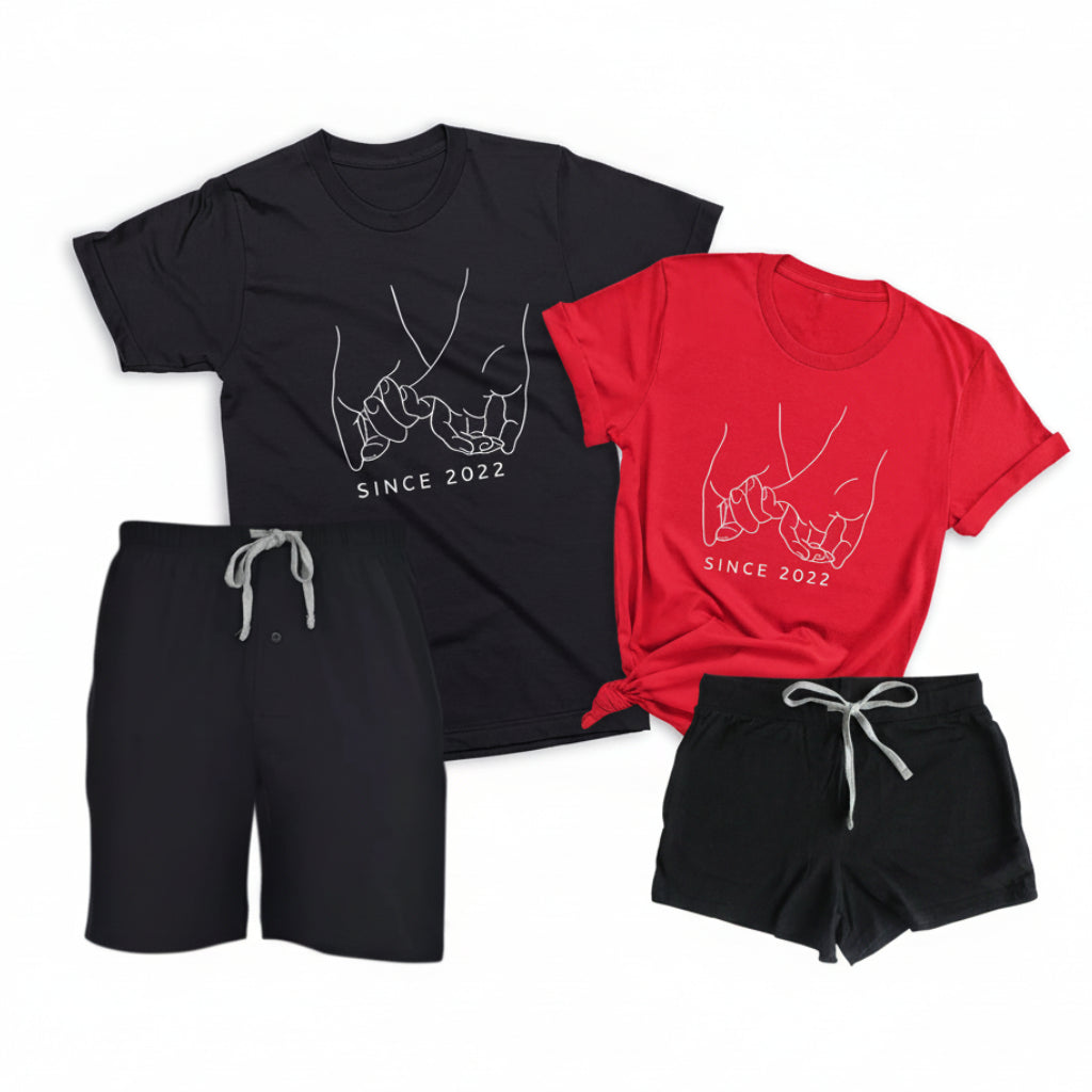 Personalized matching pajamas for couples with black boxer shorts, black men’s t-shirt, and red women’s t-shirt featuring custom date pinky promise design