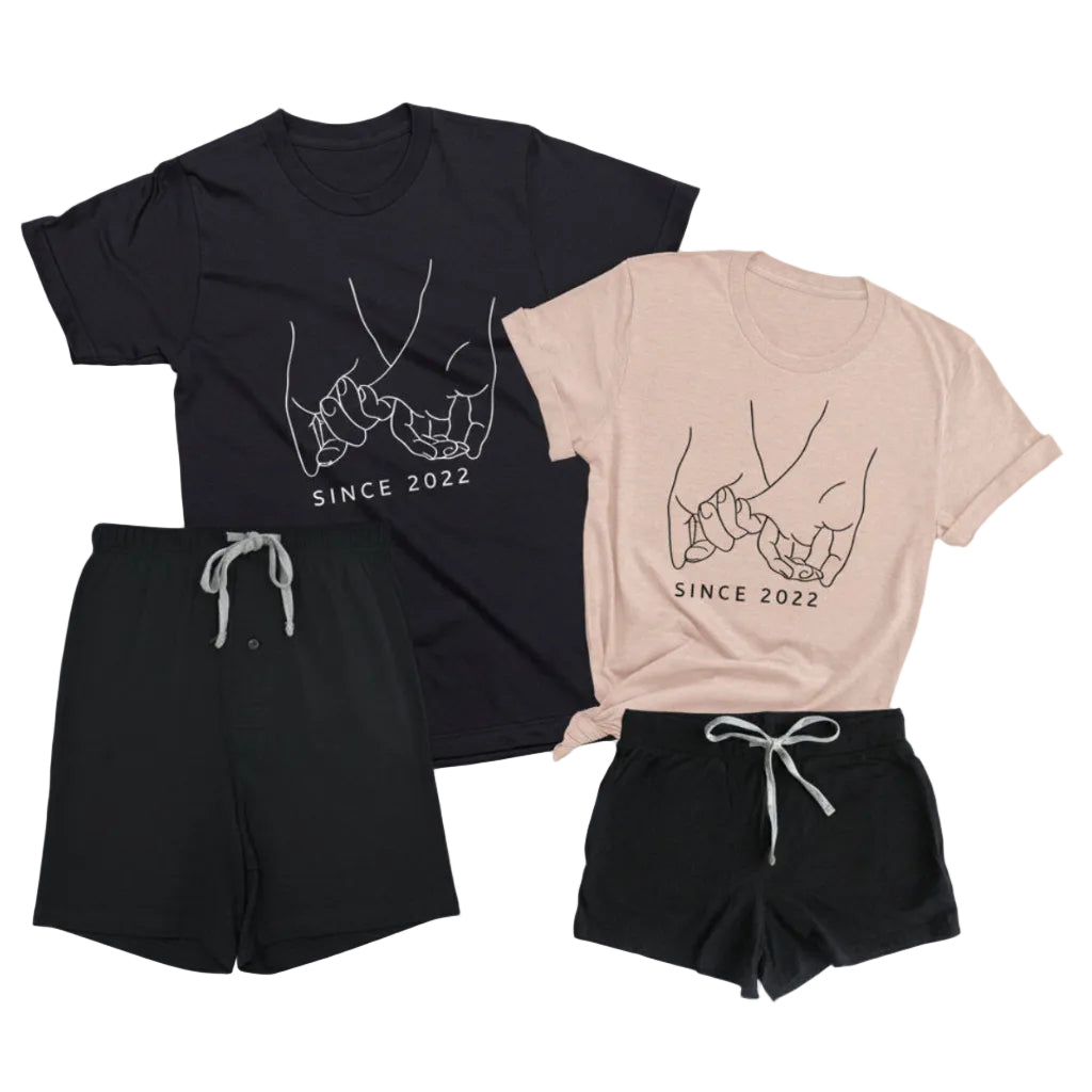 Personalized matching pajama set for couples with black boxer shorts, black men’s t-shirt, and peach women’s t-shirt featuring custom date pinky promise design on white background