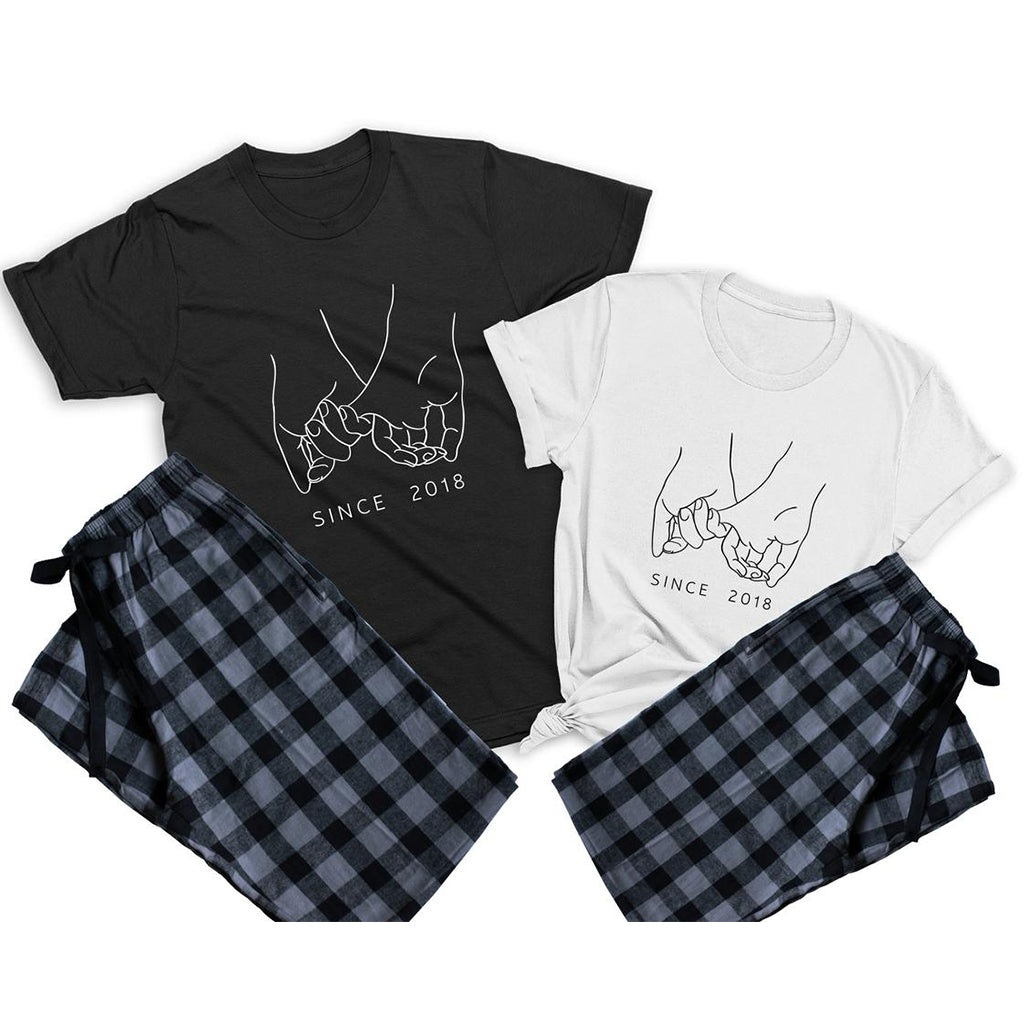 Holding pinkies couple matching pajamas –1