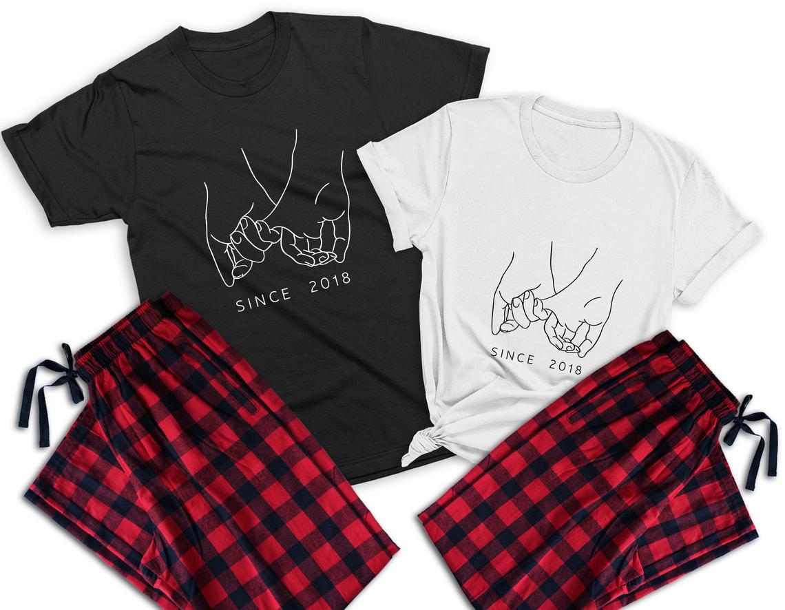 Holding pinkies couple matching pajamas –1